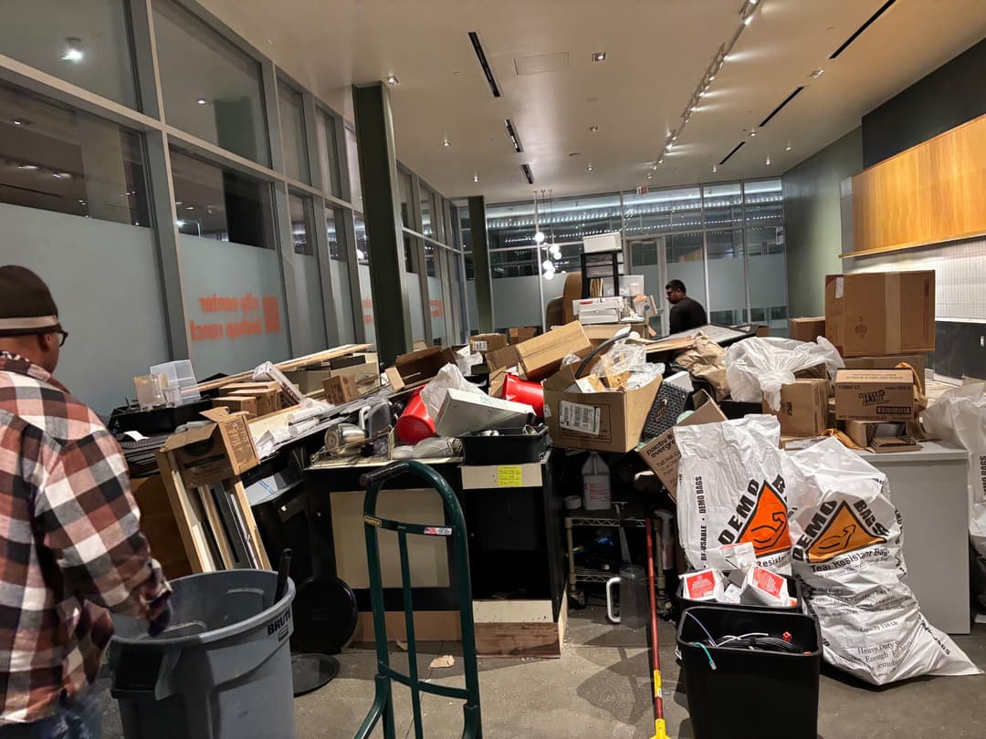Office and retail junk removal with boxes, fixtures, and debris staged for hauling